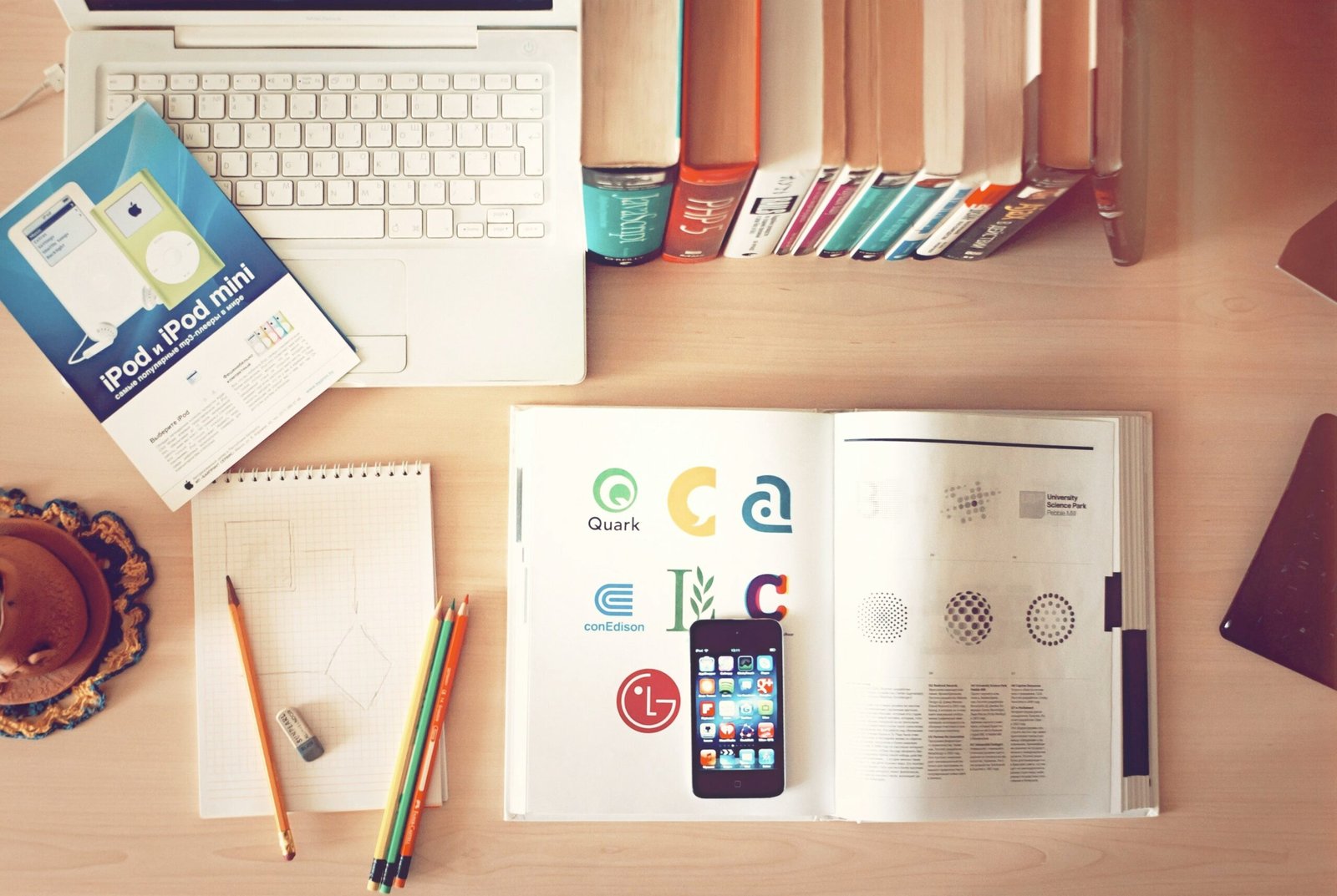 pencils and smartphone on pencils and smartphone on top of books